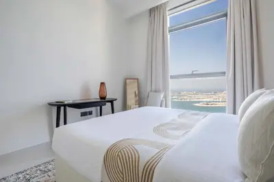 a bedroom with a white bed and a large window at Frank Porter - Marina Vista Tower 2 in Dubai