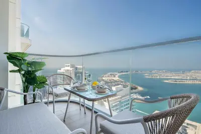 a balcony with a table and chairs and the ocean at Frank Porter - Marina Vista Tower 2 in Dubai