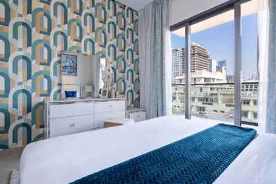a bedroom with a bed and a large window at Frank Porter - Eleganz 2 by Danube in Dubai