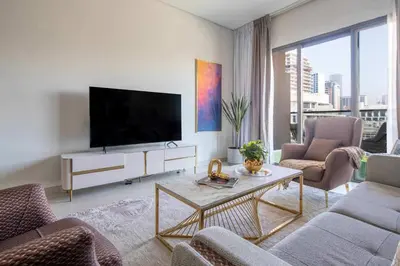 a living room with a flat screen tv on a wall at Frank Porter - Eleganz 2 by Danube in Dubai