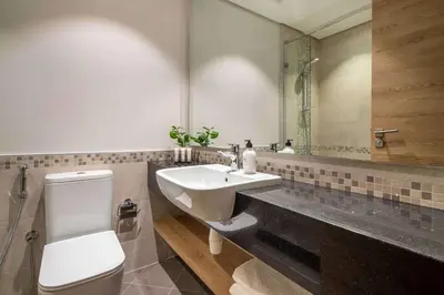 a bathroom with a sink and a toilet and a mirror at Frank Porter - Eleganz 2 by Danube in Dubai