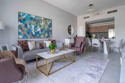 a living room with a couch and a table at Frank Porter - Eleganz 2 by Danube in Dubai
