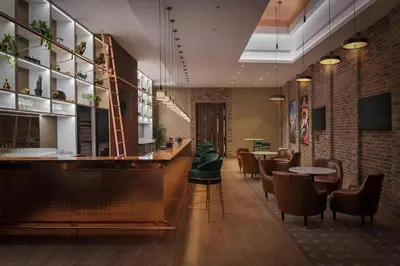 a restaurant with a bar and some chairs and tables at 2BR Apartment in Paramount Midtown with Infinity Pool in Dubai