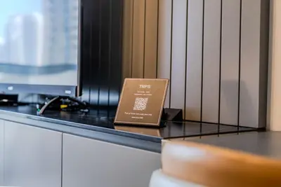 a book sitting on a counter in front of a tv at TRPS - MAG 318, Business Bay - Walk to Dubai Mall, Furnished Apt, Premium Amenities in Dubai