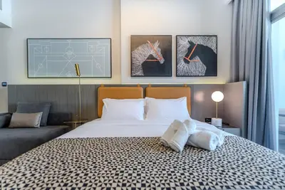 a bedroom with a bed with two pillows on it at TRPS - MAG 318, Business Bay - Walk to Dubai Mall, Furnished Apt, Premium Amenities in Dubai