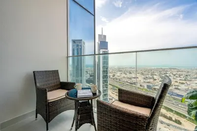 a balcony with two chairs and a table with a view at GuestReady - Forte Tower | Steps from Dubai Mall in Dubai