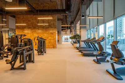 a gym with treadmills and elliptical machines at GuestReady - Forte Tower | Steps from Dubai Mall in Dubai