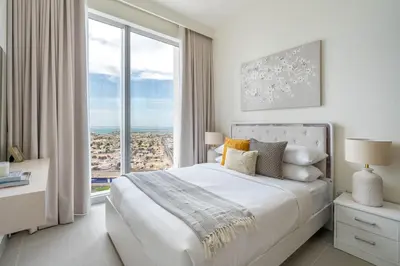a bedroom with a large bed with a large window at GuestReady - Forte Tower | Steps from Dubai Mall in Dubai