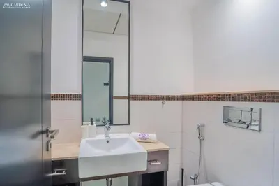a bathroom with a sink and a mirror at SkyView Tower - Dubai Marina View - Lit Apartment in Dubai