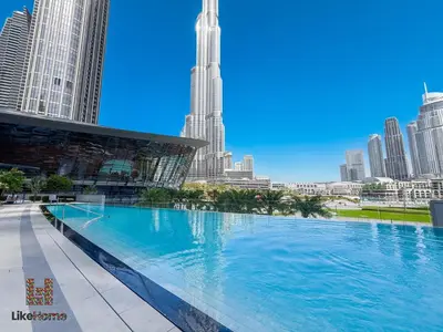 a large swimming pool in a city with tall buildings at Wake Up to Burj Khalifa Views Next to Dubai Mall Luxury 2BR Downtown Like Home in Dubai