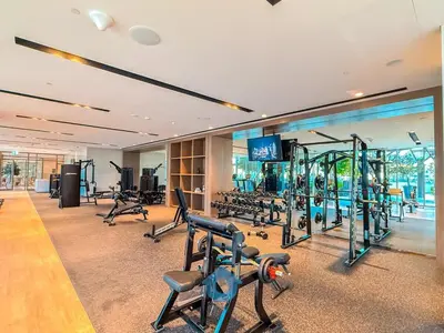 a gym with treadmills and exercise equipment in a building at Enjoy Best Burj Khalifa View from Balcony Next to Dubai Mall Luxury 2BR Like Home in Dubai
