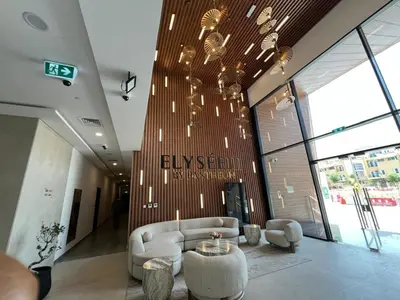 a lobby with a couch and a table in a building at Captivating Studio in Jvc Elysee in Dubai