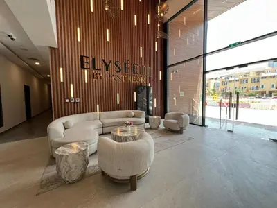 a lobby with a couch and a table in a building at Captivating Studio in Jvc Elysee in Dubai