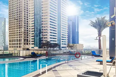 a swimming pool in a city with tall buildings at LUX The Dubai Marina View Suite 3 in Dubai