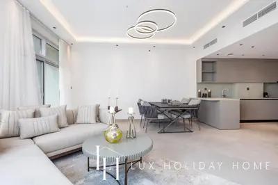 a living room with a couch and a table at LUX The Dubai Marina View Suite 3 in Dubai