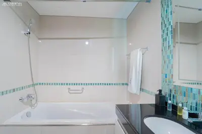 a bathroom with a tub and a sink and a mirror at Damac Heights-Palm Jumeirah View-Elite Living in Dubai