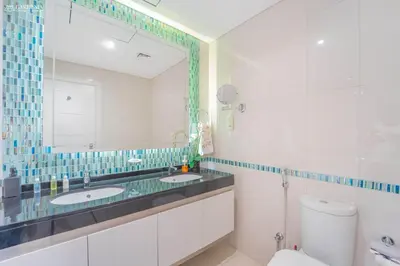 a bathroom with two sinks and a mirror at Damac Heights-Palm Jumeirah View-Elite Living in Dubai
