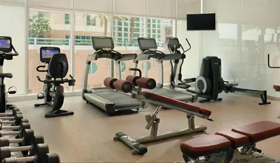 a gym with several cardio equipment in a room at Damac Heights-Palm Jumeirah View-Elite Living in Dubai