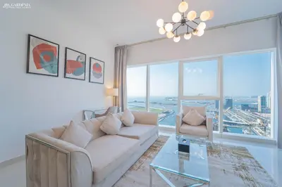 a living room with a couch and a glass table at Damac Heights-Palm Jumeirah View-Elite Living in Dubai
