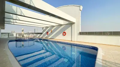 a swimming pool on top of a building at Red Residence, Sports City - 2 Bedroom Apartment - Allsopp & Allsopp in Dubai