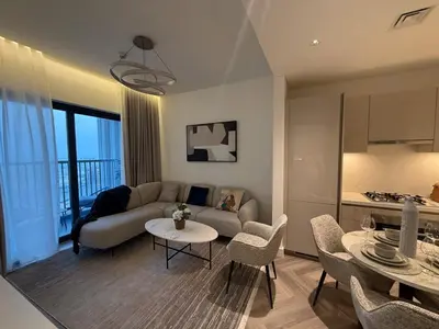 a living room with a couch and a table at Crest haven suite in Dubai