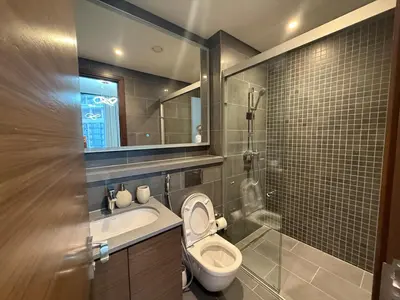 a bathroom with a toilet and a sink and a mirror at Crest haven suite in Dubai