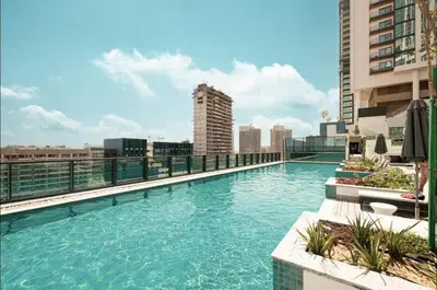 a swimming pool on the roof of a building at Crest haven suite in Dubai