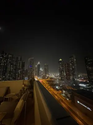 a view of a city at night with traffic at DT Penthouse • 250sqm • Billiards • Terrace & Pool in Dubai