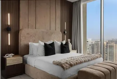 a bedroom with a large bed and a large window at 3BR Ultra Luxury Waterfront Panoramic Views with Pool, Gym, Jacuzzi -10 mins to Burj Khalifa in Dubai