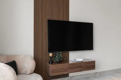 a flat screen tv hanging on a wall at 3BR Ultra Luxury Waterfront Panoramic Views with Pool, Gym, Jacuzzi -10 mins to Burj Khalifa in Dubai