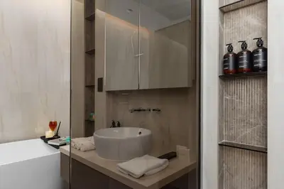a bathroom with a sink and a bath tub at 3BR Ultra Luxury Waterfront Panoramic Views with Pool, Gym, Jacuzzi -10 mins to Burj Khalifa in Dubai