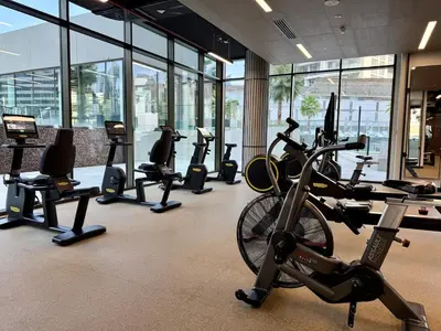 a gym with a bunch of treadms and cardio machines at 3BR Ultra Luxury Waterfront Panoramic Views with Pool, Gym, Jacuzzi -10 mins to Burj Khalifa in Dubai