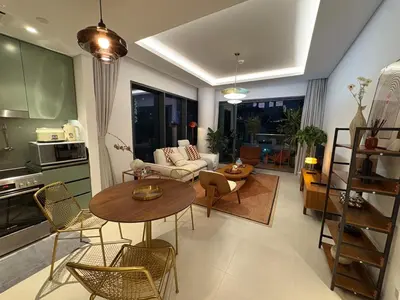 a living room with a table and chairs and a kitchen at Stylish 1BR in CityWalk, Stunning Burj Khalifa view in Dubai