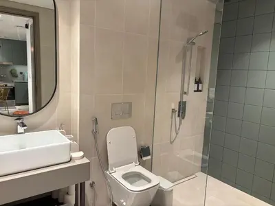 a bathroom with a shower and a toilet and a sink at Stylish 1BR in CityWalk, Stunning Burj Khalifa view in Dubai