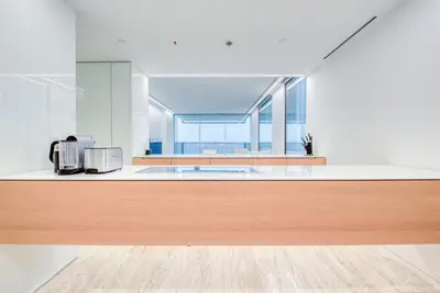 a kitchen with white walls and a wooden counter top at Luxury Apartment at Muraba Residence in Dubai