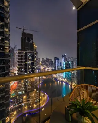 a balcony with a view of a city at night at Bay Central Marina Suite with Exceptional Views in Dubai