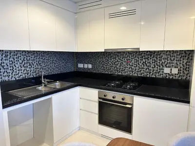 a kitchen with white cabinets and a sink at Skyline 2BR - AYKON CITY Tower C-Business Bay 5101 in Dubai