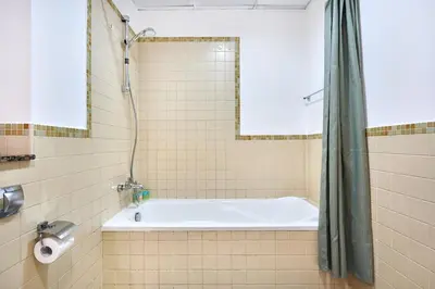 a bathroom with a tub and a shower at Family Stay JBR 3BR and maids room l Walk to Beach l Marina in Dubai