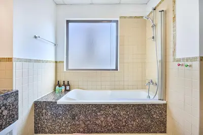 a bath tub in a bathroom with a window at Family Stay JBR 3BR and maids room l Walk to Beach l Marina in Dubai