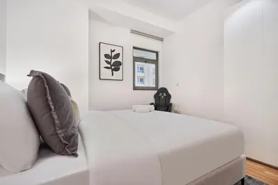a white bed in a room with a window at Family Stay JBR 3BR and maids room l Walk to Beach l Marina in Dubai