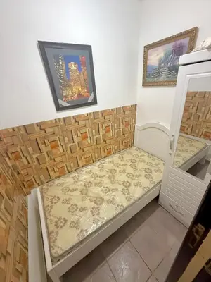 a small room with a bed in the corner at Cool valley homes in Dubai