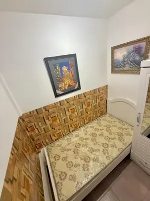 a bed in a room with two pictures on the wall at Cool valley homes in Dubai