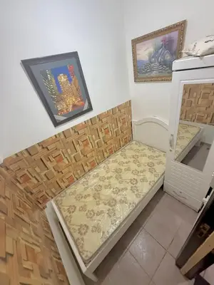 a small kitchen with a bench in the corner at Cool valley homes in Dubai