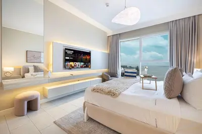 a bedroom with a large bed and a large window at Luxurious 4BR La Vie JBR Private Beach Pool Panoramic Sea and Dubai Eye Views Drone Show Perfect for Family and Friends in Dubai