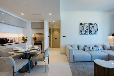 a living room with a couch and a table at Vacationer l Stunning 1 Bed l Sea View l Private Beach Access in Dubai