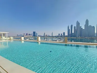 a large swimming pool with a city skyline in the background at Vacationer l Stunning 1 Bed l Sea View l Private Beach Access in Dubai