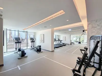 a gym with treadmills and exercise equipment in a building at Vacationer l Stunning 1 Bed l Sea View l Private Beach Access in Dubai