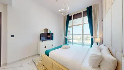 a bedroom with a large bed with a window at Vacationer l Elegant 1 Bedroom l Arjan l Pool with View Deck in Dubai