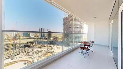 an apartment balcony with a view of a city at Vacationer l Elegant 1 Bedroom l Arjan l Pool with View Deck in Dubai