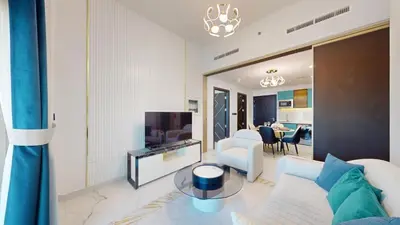 a living room with a couch and a tv at Vacationer l Elegant 1 Bedroom l Arjan l Pool with View Deck in Dubai